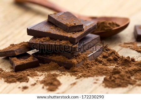 Dark Chocolate with Cocoa on wooden table