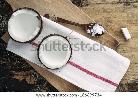 Coconut and coco oil on wooden background