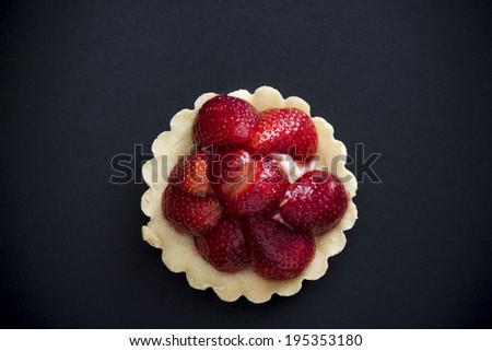 Strawberry tart on black background