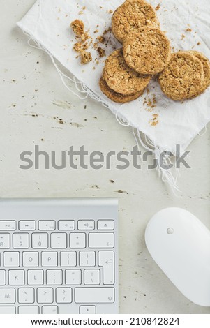 Office Desk with keyboard, mouse and cookies