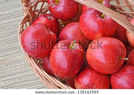 Ripe, red Gala apples in a wicker basket - closeup.