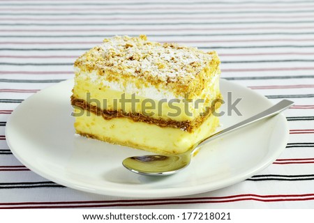 Napoleon - vanilla and custard cream cake with whipped cream and dusting.