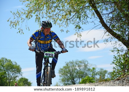 CLUJ-NAPOCA, ROMANIA - APRIL 27, 2014: Unidentified middle-aged man on mountain bike competes at 