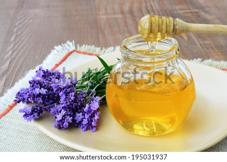 Herbal honey in jar with fresh lavender flower - sweet food.