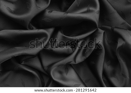 Black silk with small leaf pattern.