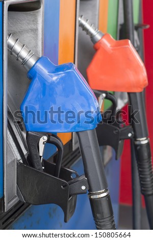 close up side view fuel nozzle fuel oil gasoline at petrol filling station