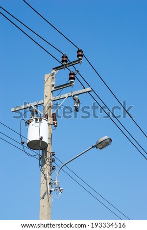 Transformer on Electricity post, high power station. High voltage with blue sky