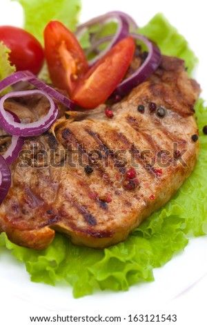 Grilled meat steak with herbs and tomatoes, onions, peppers, isolated on white background