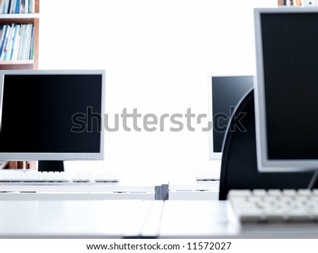 Three LCD screens in an office setup