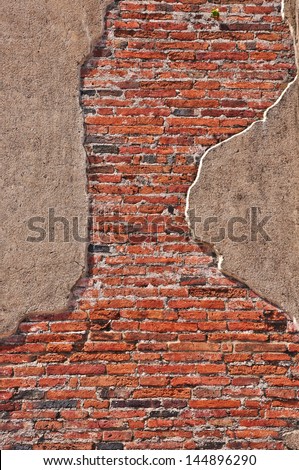 old brick wall with cracked stucco layer background in Thailand