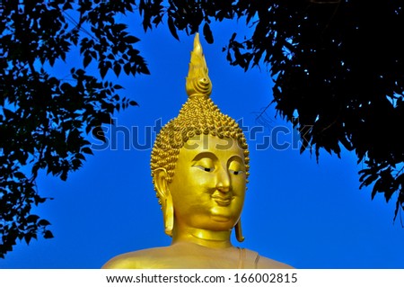 The Big Buddha under tree frame  at Wat Muang Temple Angthong Thailand