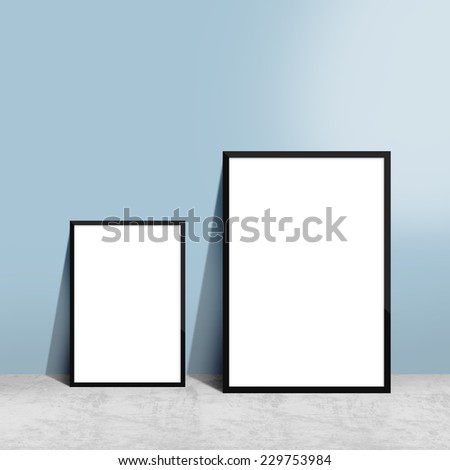 two blank posters in frames hanging on wall