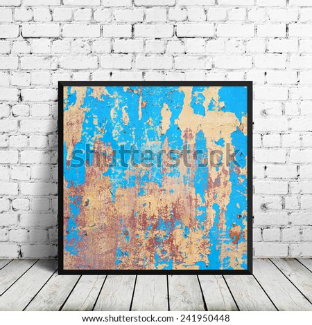 grunge poster in frame over brick wall
