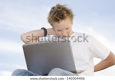 Fair-haired pretty guy rest with laptop in nature