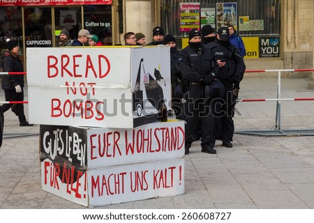 Munich, Germany -February 07, 2015: Police cordon and signs banners on protest rally anti-NATO peaceful demonstration in the center of Europe