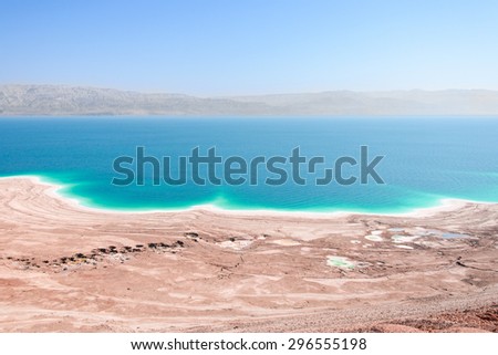 Aerial view Dead Sea coast in desert landscape with therapeutic curative mud and mineral salt
