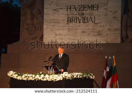 RIGA, LATVIA  AUGUST 23, 2014: President of Latvia Andris Berzins giving a speech in front of the monument of Freedom at the \