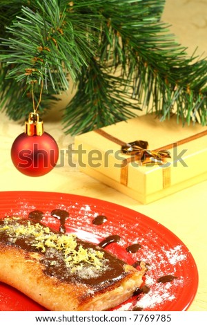 the holiday- the dessert folding: the pancake stuffed with the white cheese with almonds, glades with the warm chocolate, sugared with powder , with the lemon, with the chocolate