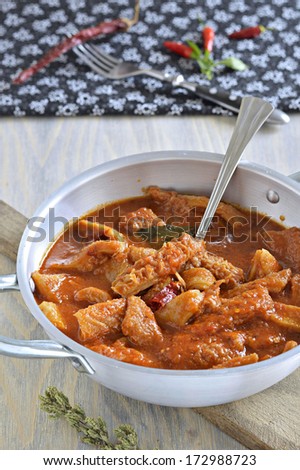 Tripe soup with tomatoes, spicy chili, basil, oregano in a metal pan. Italian food, South Italy.