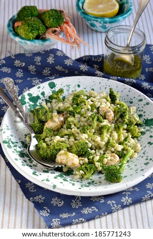 Broccoli salad with pearl barley and Norway lobster(Shrimp scampi), decoration: cutlery, salad dressing, shrimp scampi, broccoli.