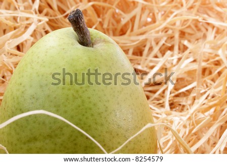 A single pear on paper shipping material.