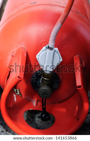 A propane tank showing condensation/freezing on the connection to the hose