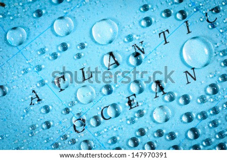 \'Atlantic Ocean\' text with water droplets suggesting rain on blue