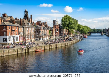 York, United Kingdom - August 7, 2015: View over the River Ouse to the pedestrian area in the city of York, UK.York is a historic walled city in North Yorkshire, England.