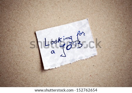 Looking for a Job message,written on piece of paper, on cardboard background. Space for your text.