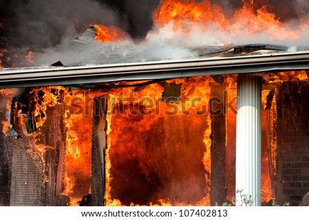 closeup of house on fire, fully involved