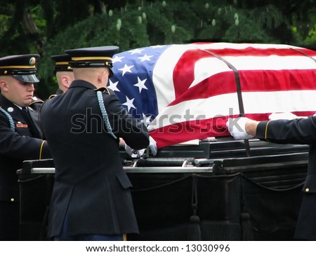 flag-covered casket on caisson at military funeral (soft focus)