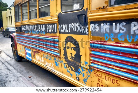 HAVANA, CUBA - MARCH 22, 2015 - school bus on Havana street, covered with political messages urging the freeing of 5 political prisoners that were held in the US.
