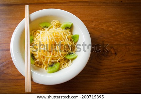 Sweet with fruit and chopsticks Japanese style like noodle menu on wood table