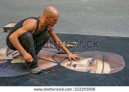 FLORENCE, ITALY - AUGUST  10, 2014: unknown artist  draws a  Lady with an Ermine (from  Leonardo da Vinci ) on the pavement by chalk, Florence, Italy