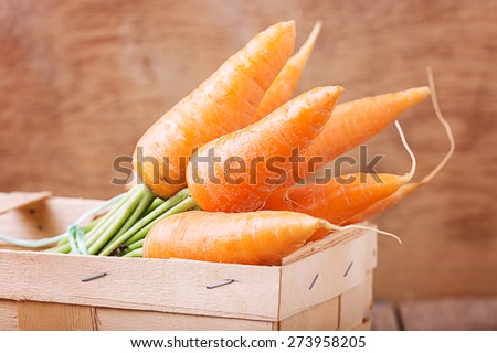 Fresh carrots in a wooden box  (horizontal photo)