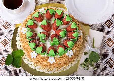 Sponge cake with whipped cream and strawberries. Decorated biscuit crumbs