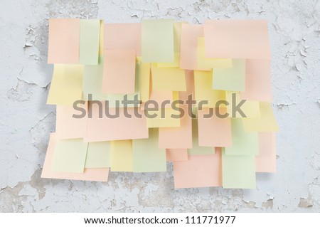 A lot of note papers on old white wall