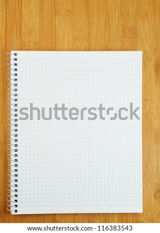 White blank notebook on wooden background