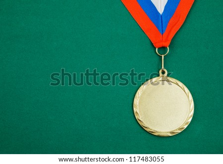 Gold medal with ribbon on green velveteen