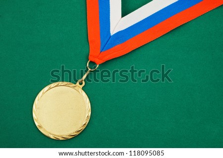 Gold medal with ribbon on green velveteen