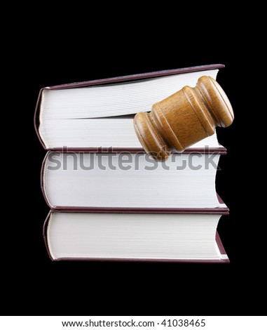 Judge's gavel and stack of legal books isolated on black