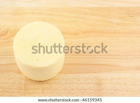 Block of cheese on wooden background