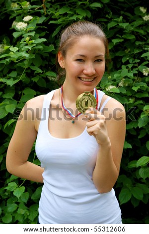 Fitness girl with gold medal outdoor