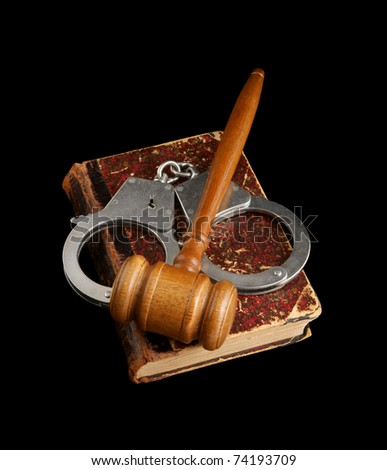 Judge\'s gavel and handcuffs on old legal book isolated