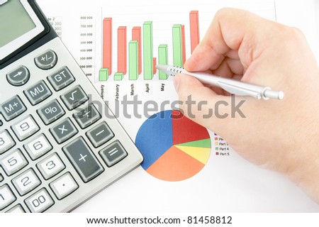 Calculator, diagram and pen in hand close up