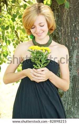 Woman with yellow flower smiling