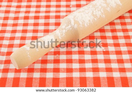 Rolling pin with flour on tablecloth