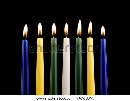 Seven candles isolated on black background