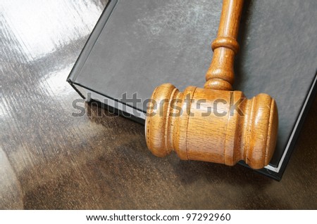 Judge's gavel and legal bookon wooden table