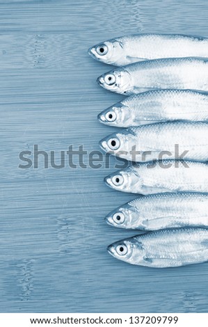 Bleak fish on wooden background  in blue tone